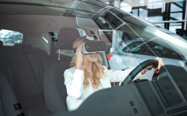 Cedno dekle sedi za volanom avtomobila s 3D ocali virtualne resnicnosti 7.4.2024